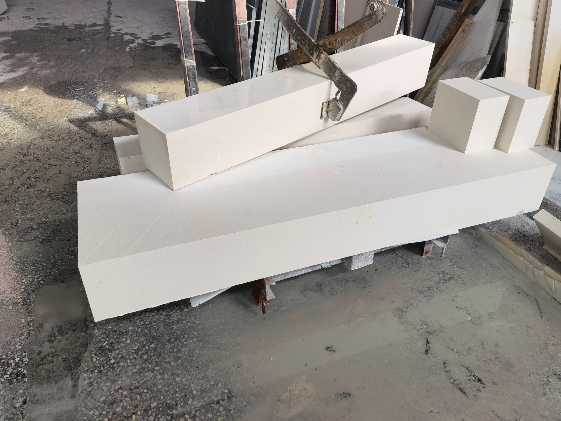 Large white marble blocks and slabs staged in the Cascadia Stone yard, ready for selection